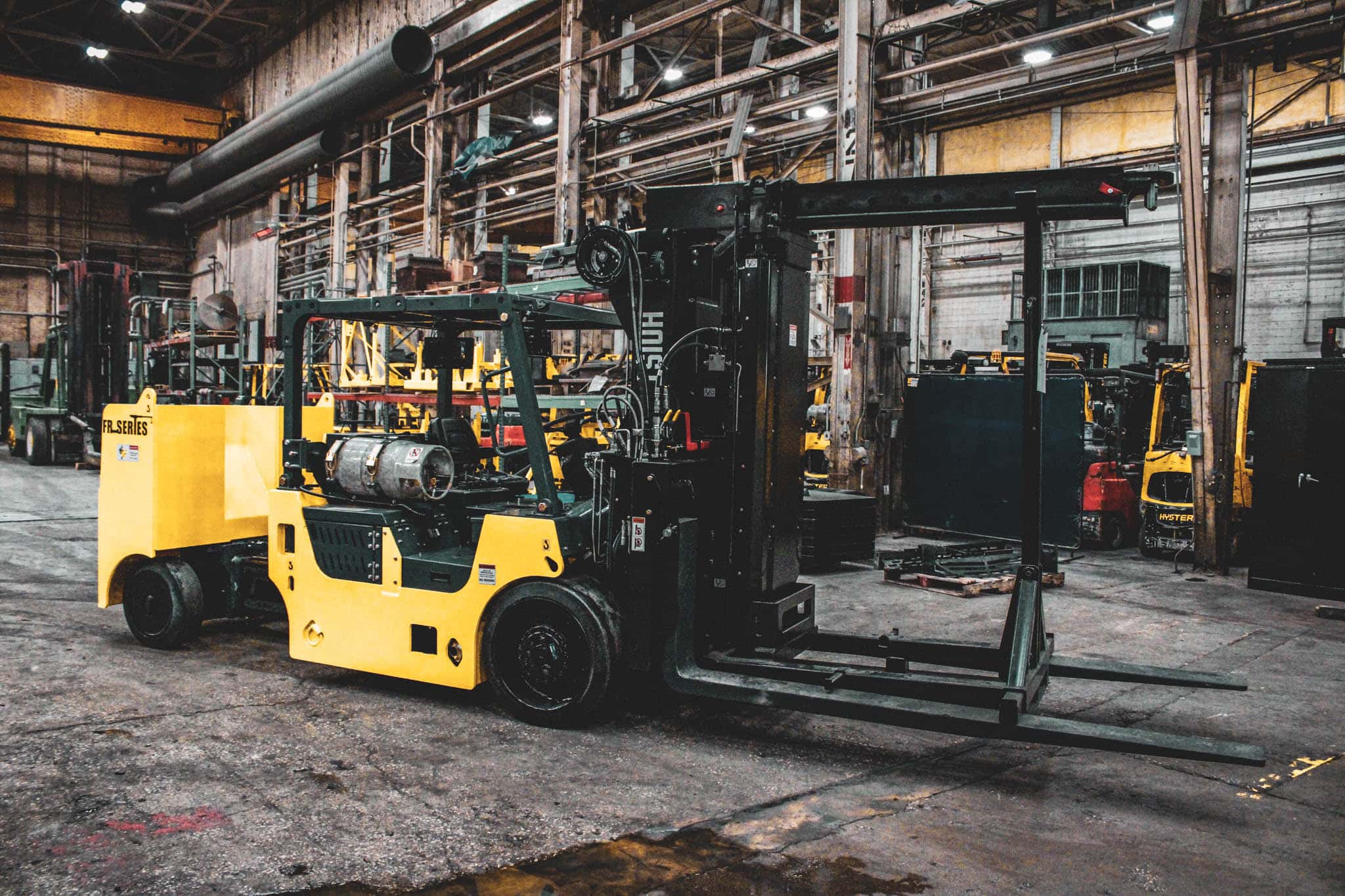 black and yellow forklift in a factory