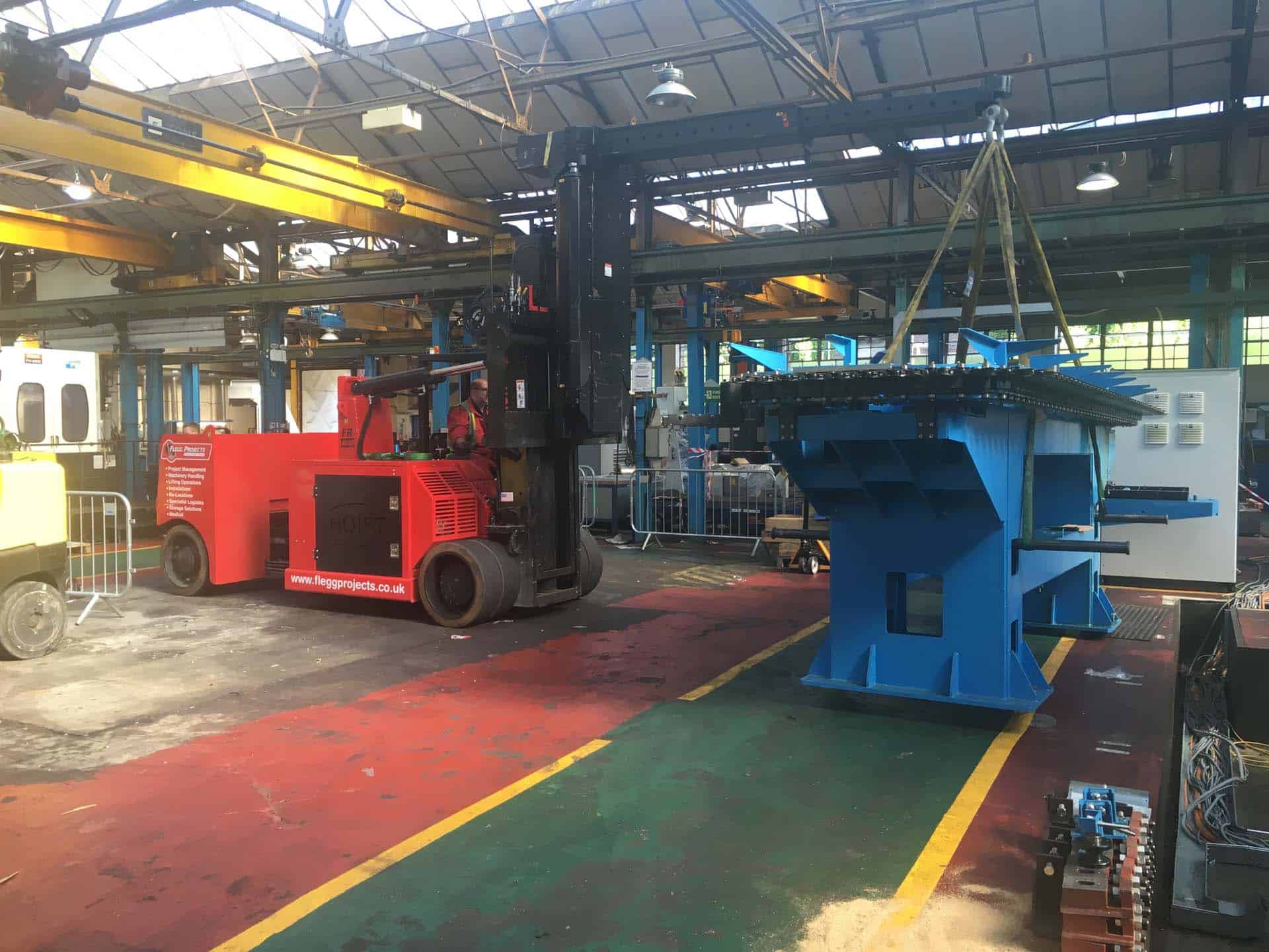 forklift moving equipment in factory